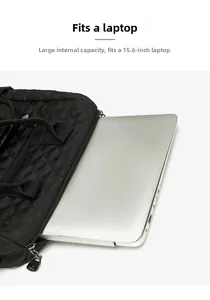 Detail showing the large capacity interior fitting a 15.6 inch laptop in quilted bag