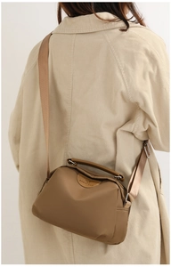 Model wearing a khaki Oxford cloth crossbody bag featuring the SOSIDI BAG embossed logo