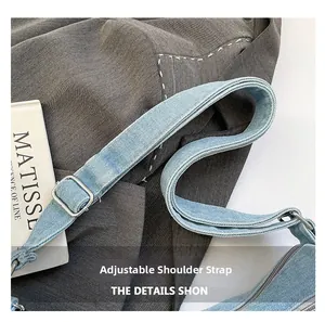 Close-up of adjustable denim shoulder strap with silver buckle and neat stitching detail
