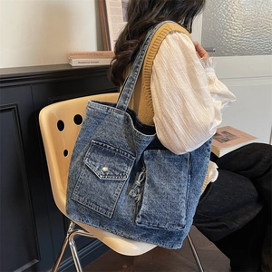 Retro blue washed denim tote bag with multi-pocket design and adjustable shoulder strap