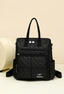 Detail of quilted nylon backpack featuring silver kangaroo logo and dual zip pockets