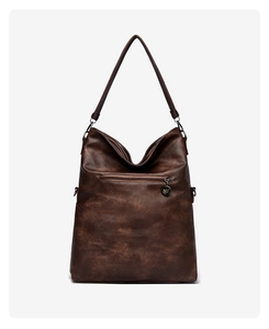 Detailed back view of brown vintage tote bag with zipper pocket and metal charm
