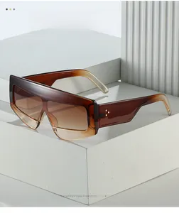 Detail showing gradient lenses and metallic rivet studs on thick oversized sunglasses