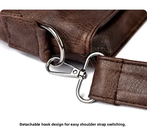 Detail of silver detachable metal hook and strap connector on vintage brown leather tote