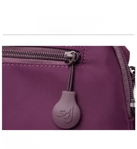 Detail of purple Oxford fabric bag featuring high-quality zipper with SDJ embossed logo