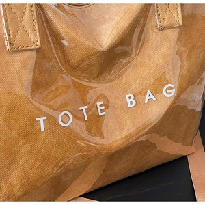 Detail of Tyvek tote bag with transparent PVC layer and printed TOTE BAG text