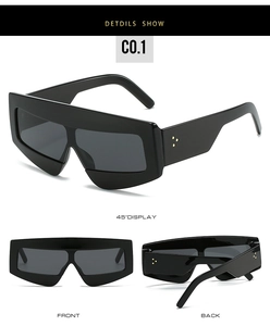 Detail view of black oversized geometric sunglasses with three golden rivets and C0.1 mark
