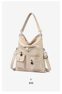 Detail of off-white PU leather bag showing lychee grain and vintage bronze zippers