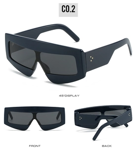 Detailed views of navy blue geometric oversized sunglasses with gold rivet accents