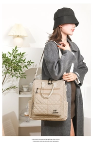 Close-up of beige quilted nylon backpack featuring diamond stitching and side pockets