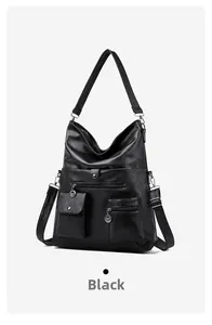 Detail of black faux leather tote bag with functional multi-pockets and silver hardware