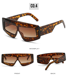 Detailed views of vintage oversized tortoiseshell sunglasses with metal rivet accents