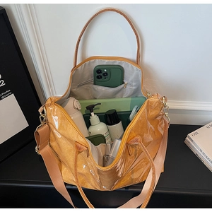 Top-down view of spacious mustard yellow Tyvek tote bag with clear PVC layer and interior pocket