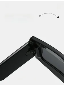 Detail of durable high-strength metal hinge on oversized glossy black fashion sunglasses