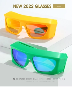 Detail view of bold Y2K wraparound sunglasses in vibrant yellow and green matte frames
