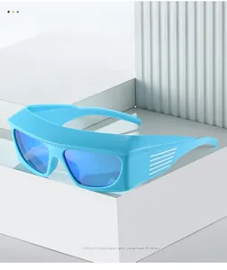 Detail of bright blue Y2K cycling sunglasses with sporty wrap-around frame and mirrored lenses