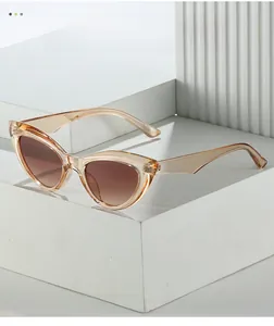 Close-up of retro cat-eye sunglasses with champagne frames on a geometric display
