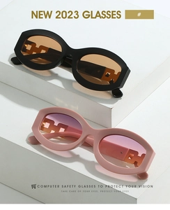 Detail of trendy oval sunglasses with unique hollow chain geometric temple design