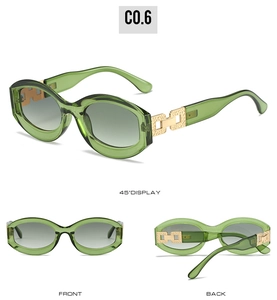 Detail view of green oval sunglasses with golden hollow chain temple design and gradient lenses