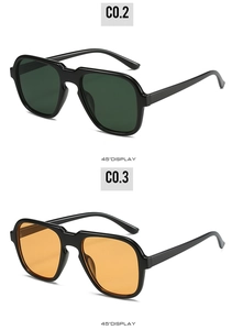 Detailed 45-degree display of retro pilot sunglasses in dark green and orange lenses