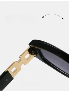 Detail of durable golden metal hollowed hinge on black oval sunglasses frame