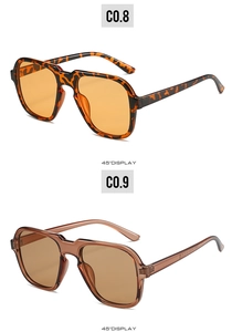 Detail view of leopard print and translucent brown oversized geometric sunglasses