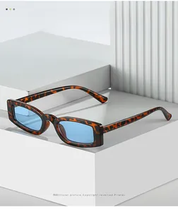 Detail of retro small square sunglasses featuring tortoise frame and light blue lenses