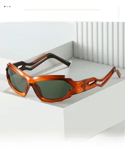 Detail of Y2K sunglasses with orange translucent frames and hollow wavy temples