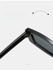 Detail view of durable metal hinges and CE certification markings on black square sunglasses