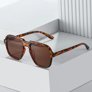 Classic tortoise shell geometric sunglasses with brown lenses on a modern white background