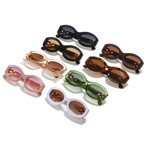 Retro oval sunglasses with hollow chain temples in eight assorted colors on white background