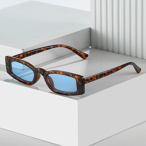 Retro tortoise square frame sunglasses with light blue lenses on white blocks