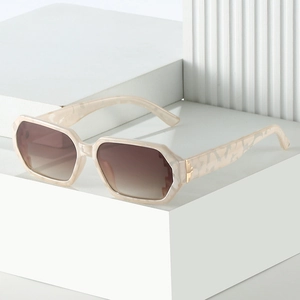 Chic cream marble square sunglasses with gradient brown lenses on minimalist stand
