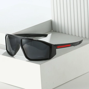 Y2K sporty wrap sunglasses with black frame and red accents on white geometric stand