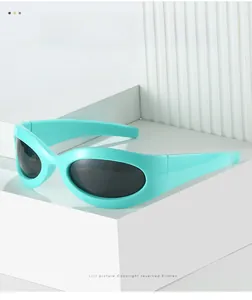 Detail of mint green Y2K sporty sunglasses with black oval lenses on geometric blocks