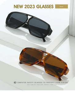 Detail of trendy double-bridge sunglasses in shiny black and tortoiseshell finishes