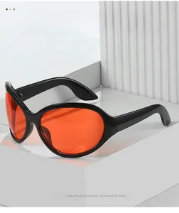 Close-up of retro oval sunglasses with glossy black frames and vibrant orange lenses