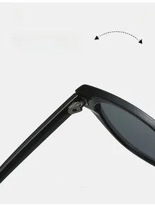 Detail showing the durable metal hinge structure of stylish black sunglasses