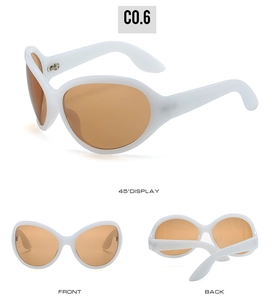 Detail view of alien style oversized sunglasses with white frames and brown lenses