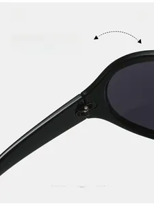 Detail of durable texture hinge and reinforced metal screws on black oversized sunglasses
