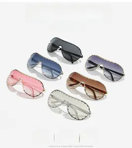 Detail of oversized shield sunglasses with metal studs in six fashionable colors