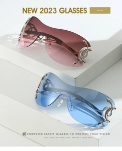Detailed close-up of Y2K sunglasses with silver snake embellishments and gradient lenses