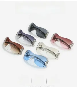Detail view of Y2K oversized sunglasses with golden snake-shaped metal hinges and tinted lenses