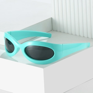 Y2K style mint green chunky oval sunglasses with dark lenses on minimalist white stand