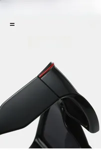 Macro detail of high-quality hinge with red accent on black sport cycling sunglasses