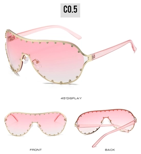 Detail view showing pink gradient lenses and gold rivet frames on oversized sunglasses