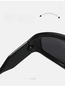 Detail of durable metal hinge on black sports sunglasses with wide frame design