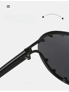 Detail of durable textured metal hinge on black oversized sunglasses with rivet accents