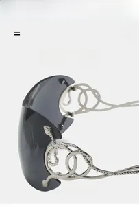 Detail of silver snake relief and intertwined ring design on Y2K oversized sunglasses