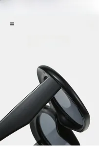 Vue détaillée de lunettes de soleil ovales noir brillant avec texture premium et charnières